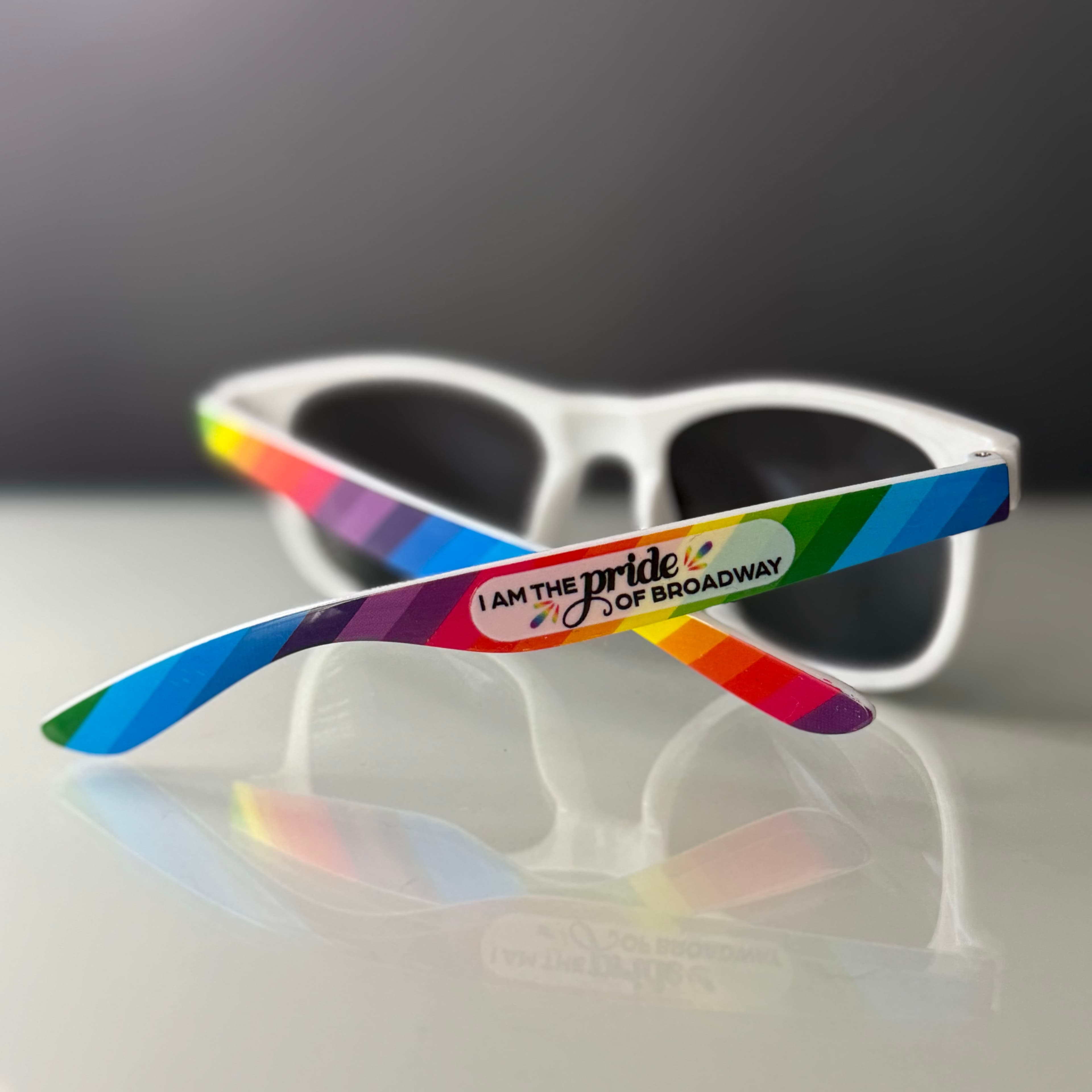 Rainbow sunglasses with "I am the pride of Broadway" printed on the side