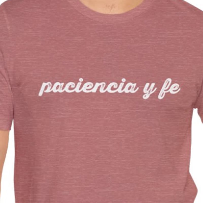 Heather mauve crew-neck t-shirt with white script text reading "paciencia y fe."