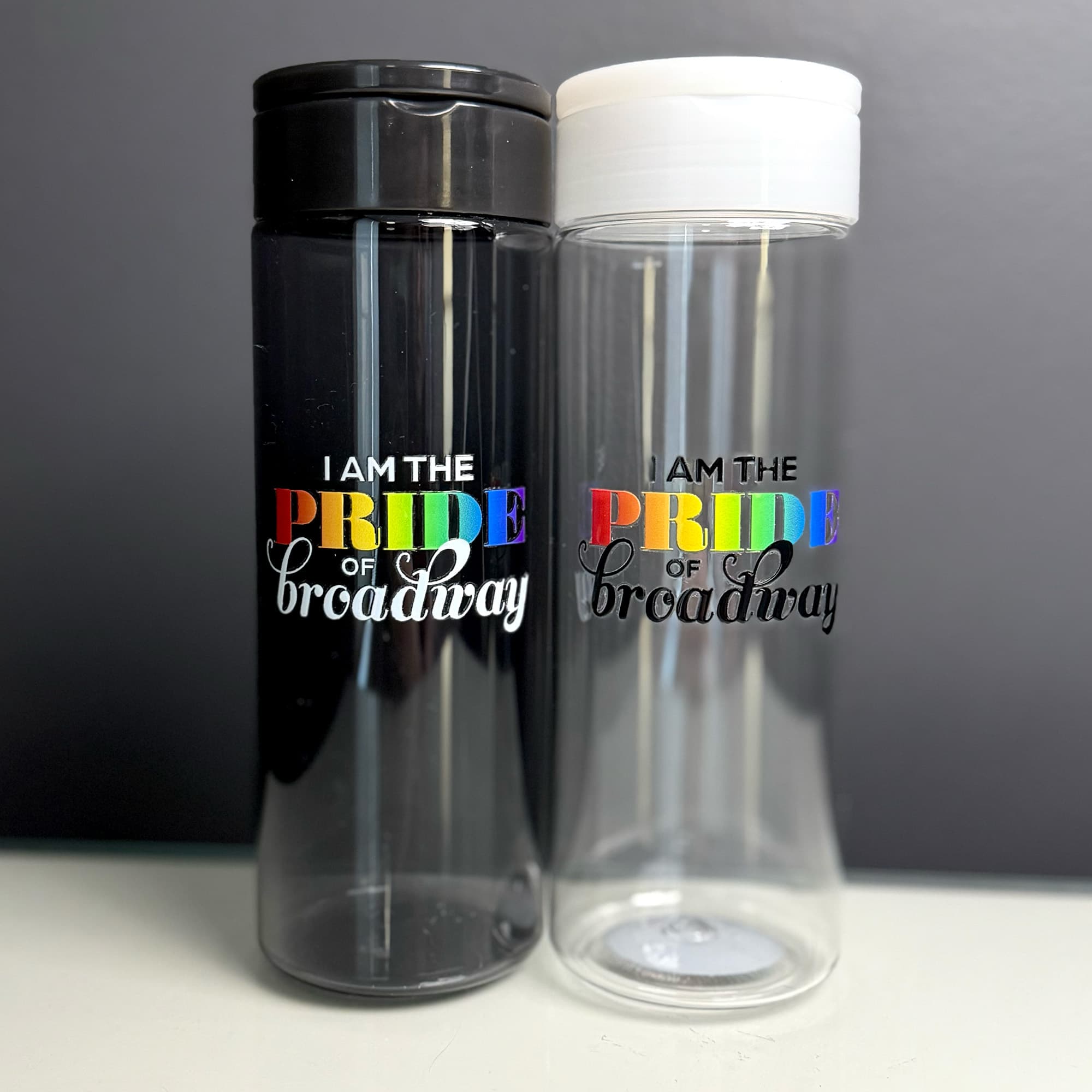 A black and clear bottle with "I am the pride of broadway" written on the outside
