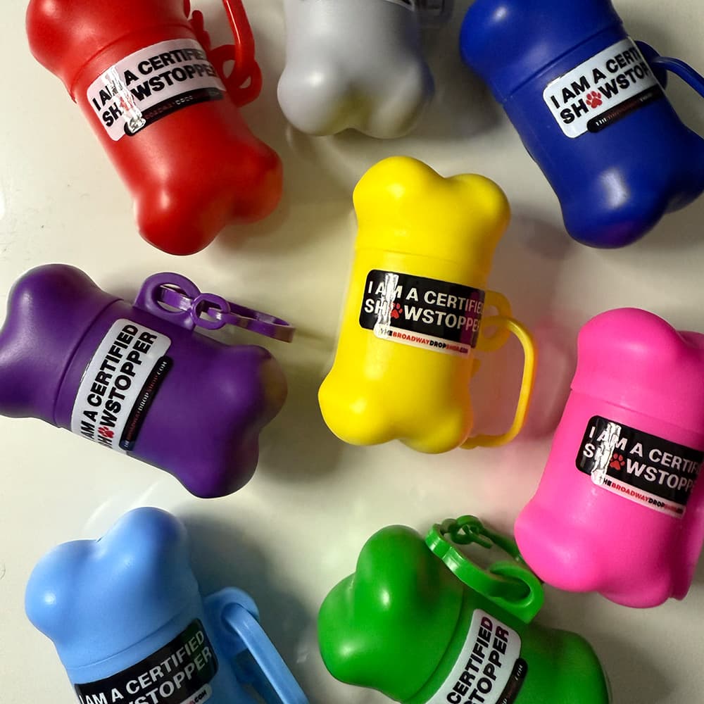 Bone-shaped dog waste bag holders in multiple colors labeled "I Am A Certified Showstopper."